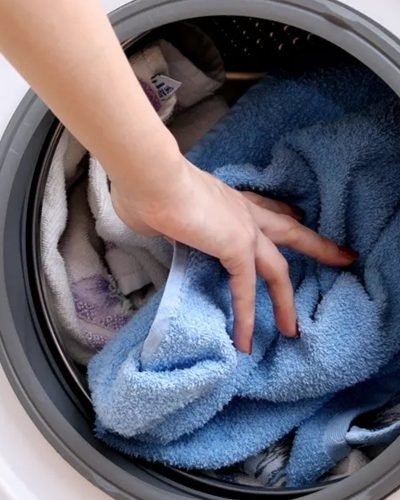 Loading laundry into a washing machine drum before a spin cycle